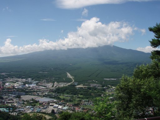 Mount Fuji hides behind clouds as seen from Mount Tenjo in Kawaguchiko Japan.