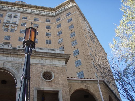 Photographed from below, a black street light and the Baker Hotel create an ominous-looking site..