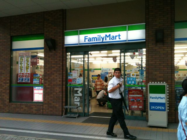 Japanese convenience stores are similar to those you find elsewhere. Many are open 24-hours. They sell food, junk food, soap, soft drinks and beer, plus a lot of other items. This is a FamilyMart convenience store. You find FamilyMart in all large cities. In Japan, convenience store prices are similar to those you find in full grocery stores.