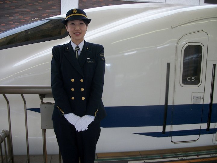 A female Shinkansen driver stands with the train she drove from Osaka-shin to Tokyo Station. Female Shinkansen drivers are somewhat rare, but increasing in number.