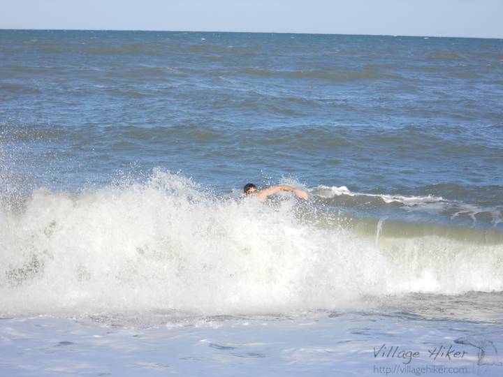 A swimmer heads home pushed by the waves as they wash inward from the Atlantic Ocean at Melbourne Beach, Florida on 10 October 2010. October is still good swimming weather, although the water can be cold and riptides strong. Snapped with a Nikon Coolpix L22. Copyright 2010 by Village Hiker Publishing Company. All rights reserved. Please do not use without permission. Contact Village Hiker for digital reproduction and high-resolution prints.