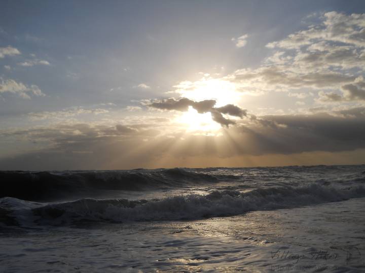 Sunlight sprays the morning sky over the Atlantic Ocean, off the coast of Melbourne Beach, Florida. The ocean sky often rewards early risers with 60 to 90 minutes of visual brilliance. When standing flat footed where sand meets waves a person 60-inches in height can see almost three miles to the slightly curved horizon. Snapped with a Nikon Coolpix L22. Copyright 2010 by Village Hiker Publishing Company. All rights reserved. Please do not use without permission. Contact Village Hiker for digital reproduction and high-resolution prints.