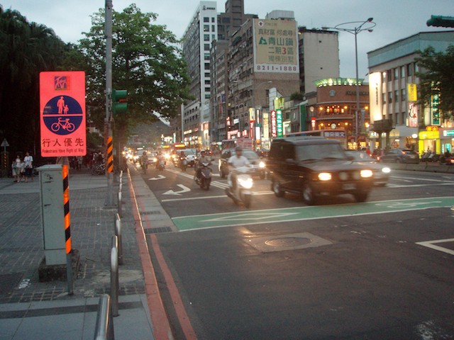 Four wheel and two vehicles mix well on the streets.