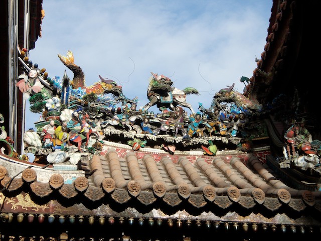 Statues and peaked roofs protect the temple from evil spirits. This temple is for the goddess Matsu. It located in the Dajia District of Taichung.