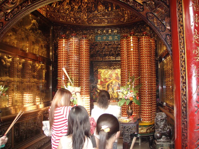 Worshippers burn incense.