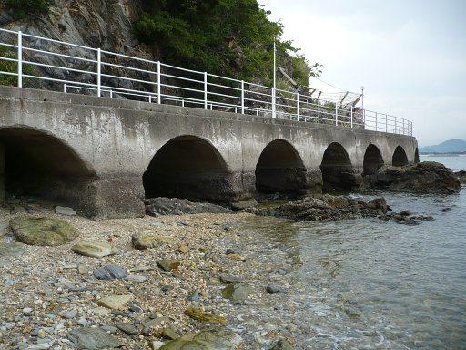 Manpa Hotel beach side walk, Wakaura, Wakayama City, Japan. The remains of the Manpa Hotel, one of three occupied by the US Navy when working in Wakayama, Japan to help repatriate British, English, French and US prisoners of war. The current Manpa Resort sits up top of the ruins. The hotels were mentioned in the writings of Buss Kerstetter to his wife Jackie in September 1945.

