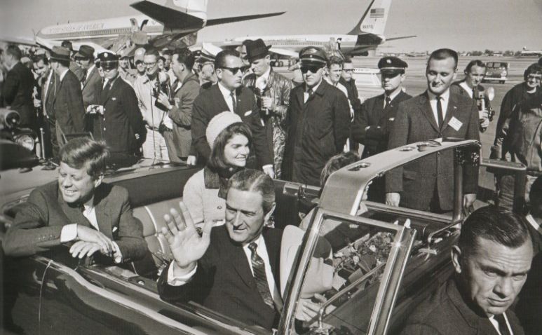 President John F. Kennedy, First Lady Jacqueline Kennedy and Texas Governor John Connally and his wife ride together in an open limousine.