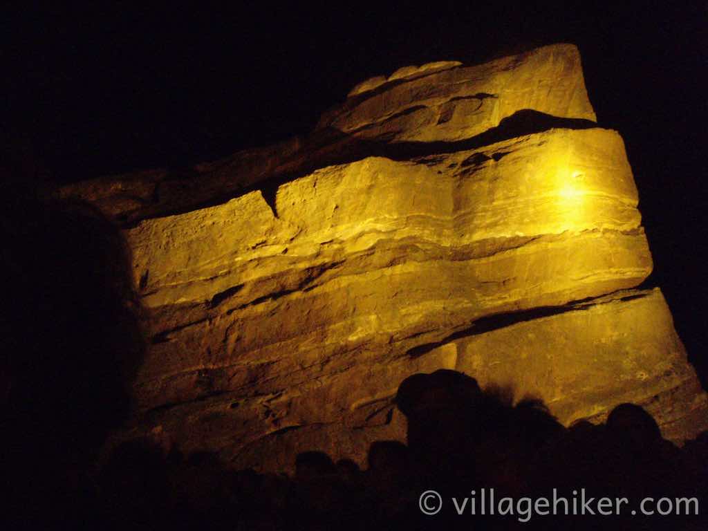 The rocks lighted at night. They look more yellow because of the light.