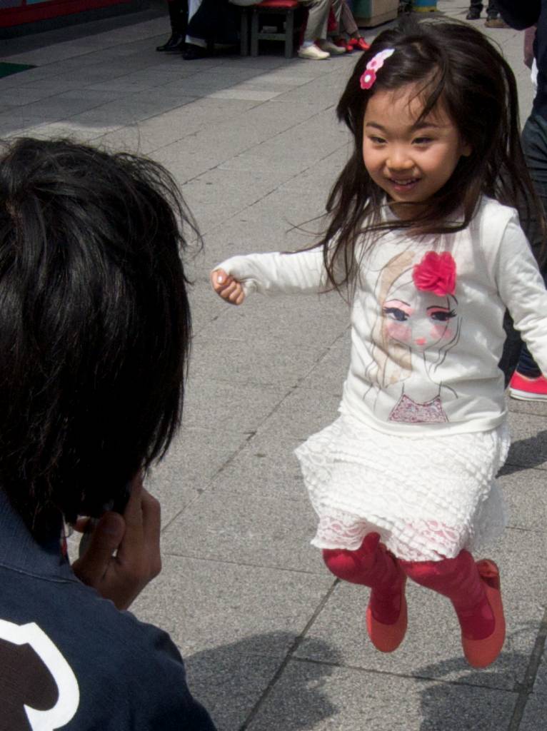 Cute Japanese Girl Jumps for Happiness During Cherry Blossom Season 2013