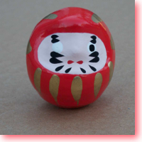 Daruma tumbling doll icon.