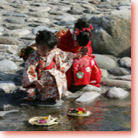 Girls release a pair of straw dolls—male and female—to carry disease and danger to the sea. This photo is copyrighted by JNTO. Used by Permission. All rights reserved.