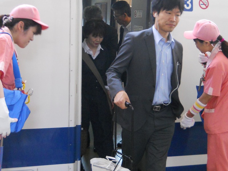 Cleaners Bow to Passengers Exiting Shinkansen Tokyo Station Japan