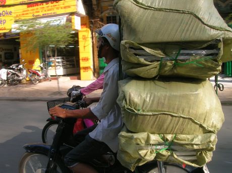 Hauling a large package on a motorbike in Ho Chi Minh City, Vietnam